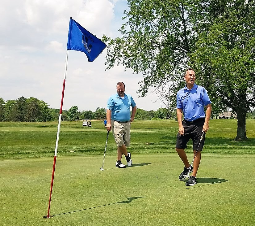 two people golfing celebrating a putt