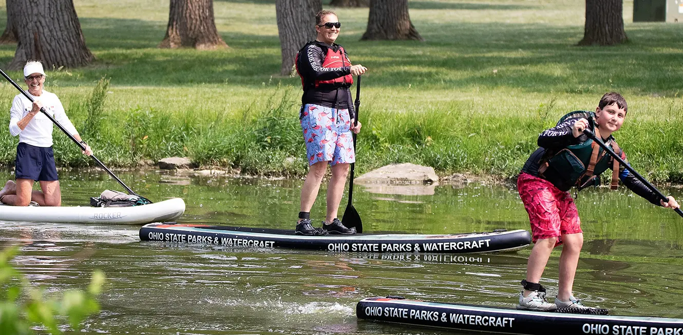 People paddle boarding at fort loramie lake