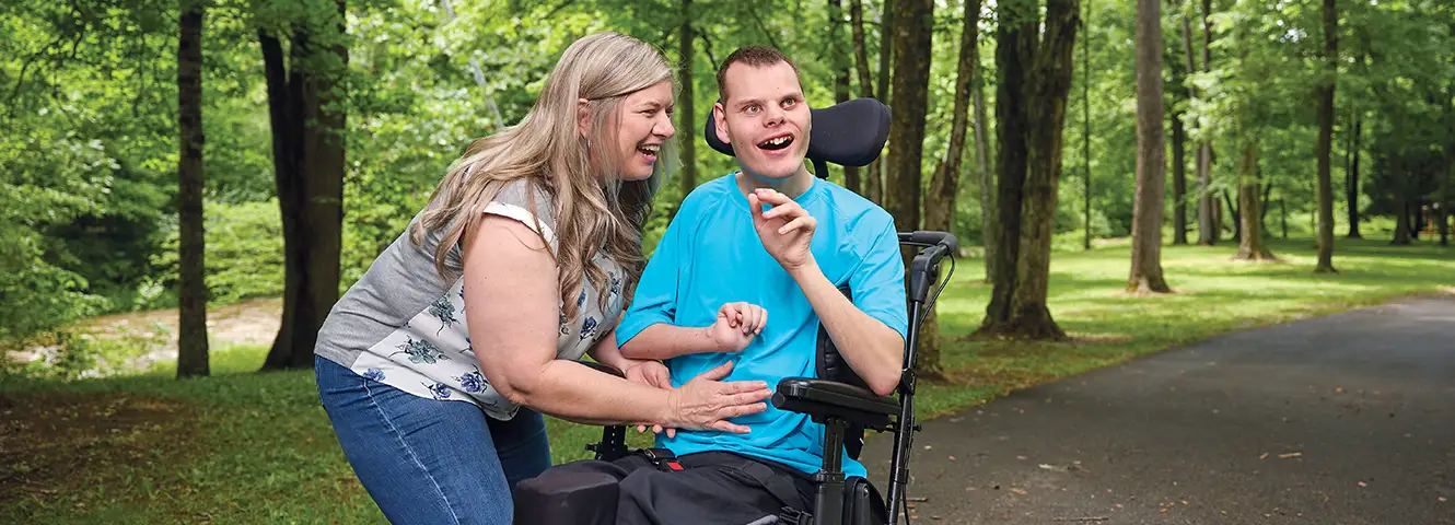 family enjoying a stroll at tawawa park in sidney ohio using tha handicap accessible paths